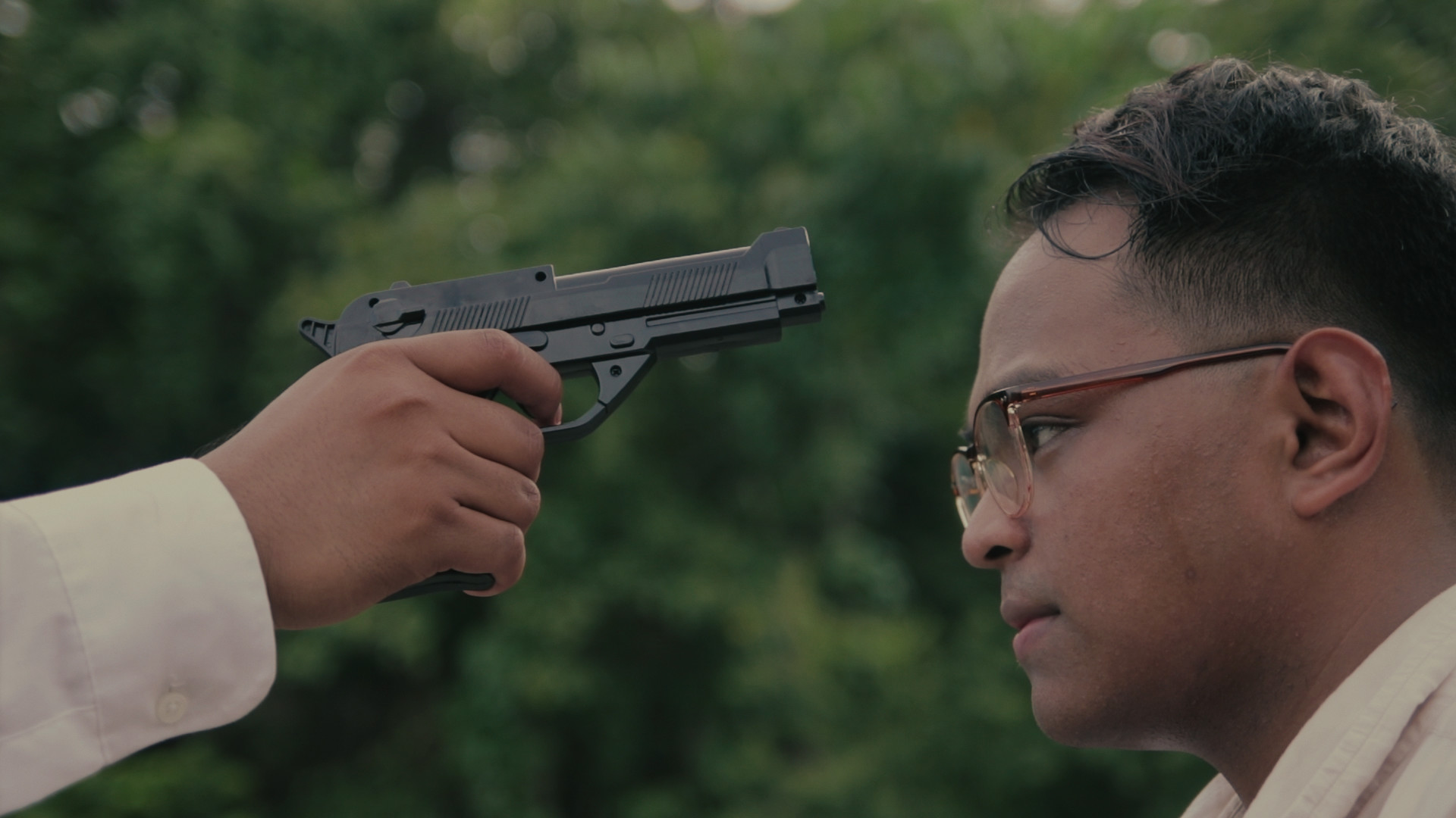 Pointing gun to guy's head