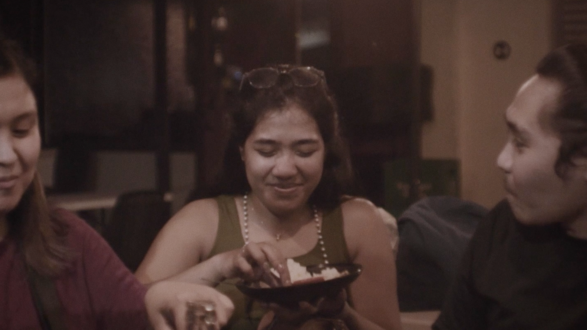 June eating food with her high school friends beside her