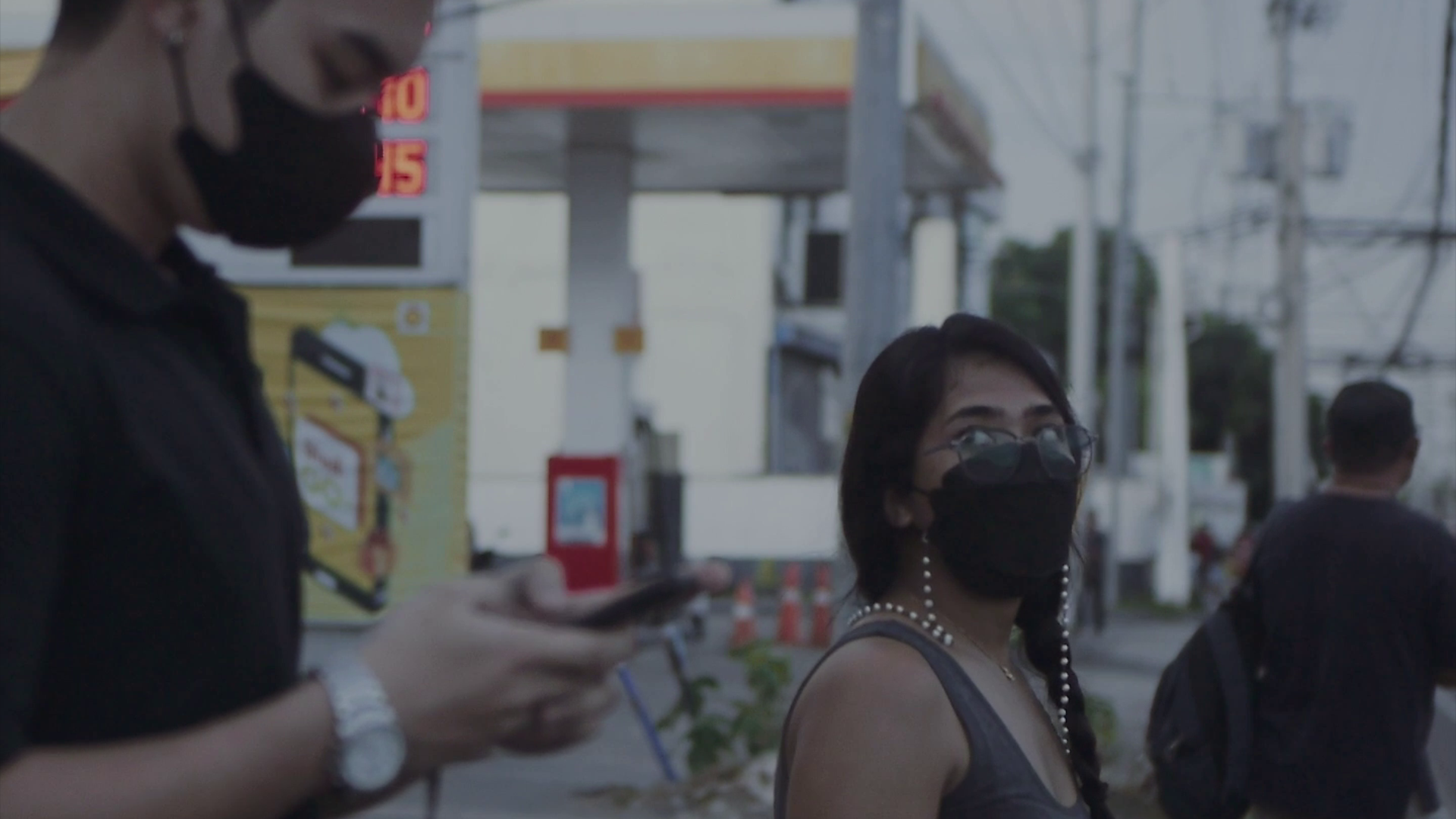 June, wearing a black face mask, staring at cute guy