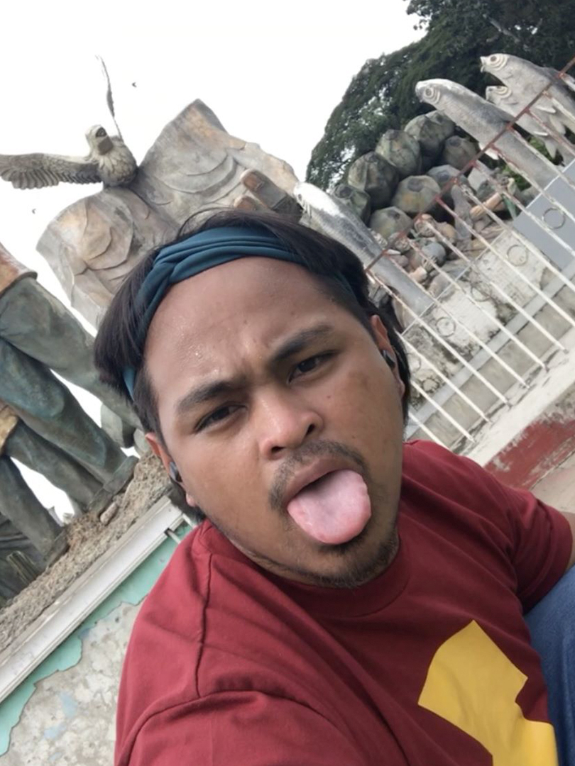 Director in front of large chicken-looking eagle, sticking his tongue out selfie